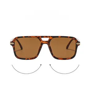 Détails de lunettes aviateur écaillées avec verres bruns et accents métalliques dorés