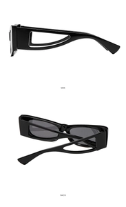 Detail of trendy black cat-eye sunglasses with thick frame and geometric hollow temples