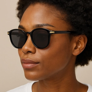 Retro square sunglasses with black frames and gold accents on a fashion model