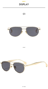 Detail view of gold metal double bridge aviator sunglasses with classic grey lenses