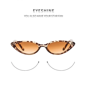 Close-up of cat-eye sunglasses featuring vintage tortoiseshell pattern and amber lenses