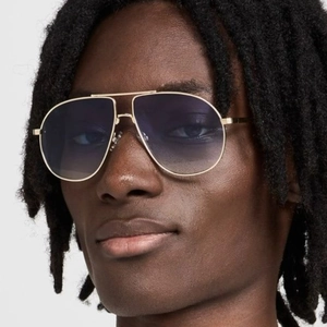 Classic aviator sunglasses with gold double bridge frames and gradient blue lenses on male model