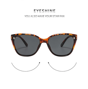 Detail of tortoise shell square cat-eye sunglasses with dark grey lenses and metal rivets