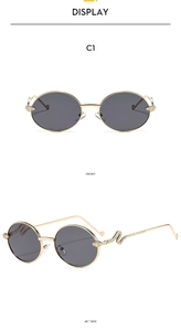 Detail of gold snake-shaped temple design on oval vintage sunglasses with dark grey lenses
