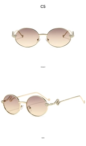 Front and side views of Y2K round metal sunglasses with a unique gold snake motif detail