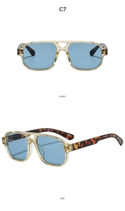 Detail view of aviator sunglasses with yellow frames, blue lenses and tortoise temples