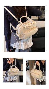Detail view of cream-white Boston bag showing backpack, crossbody, and tote modes
