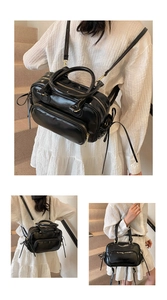 Detail of black glossy dual-use backpack and handbag with gold zippers and side lace decor