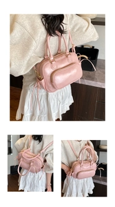 Detail showing pink glossy PU leather multi-way handbag with golden hardware and straps