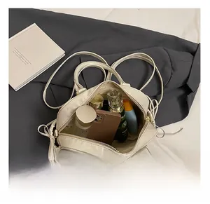 Detailed interior of the cream shoulder bag showing spacious storage for daily essentials