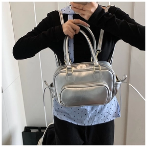 Silver metallic PU backpack detail showing golden hardware and side bow decoration