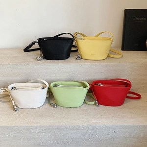 Minimalist litchi grain bucket bag in five colors on stone steps display