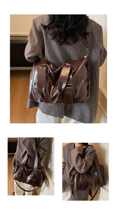 Dettaglio della borsa tote grande in pelle marrone scuro con manici robusti e ganci in metallo
