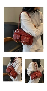 Close-up of burgundy patent leather bowling bag featuring silver buckle front pockets