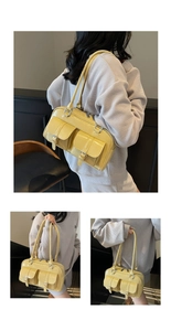 Close-up of a bright yellow patent leather bag with double buckle pockets and top handles