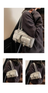 Detail of silver metallic tote bag with front buckle pockets and sleek shoulder straps