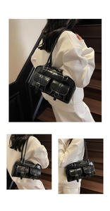 Detail of black glossy PU leather tote bag featuring dual front pockets with silver buckles