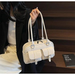 Detail view of the cream white PU leather bowling bag with stylish front flap pockets