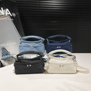 Denim crossbody bucket bags in four colors with adjustable straps and front pockets