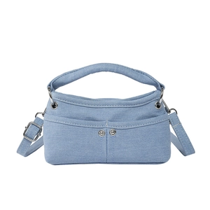 Light blue denim crossbody bag with top handle and adjustable strap on white background