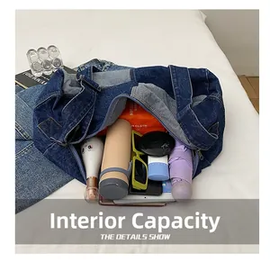 Internal capacity of retro washed denim tote bag showing various daily essentials storage