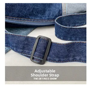 Detail of adjustable denim shoulder strap with matte black buckle and orange stitching