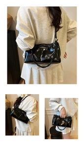 Close-up of black glossy cloud pleated bag showing versatile shoulder and hand carry styles