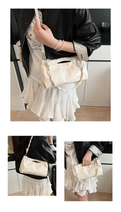 Detail showing creamy white pleated cloud bag with shiny finish in various carrying styles