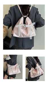 Detail of pink patent leather backpack with lace bow, pearls and heart pendant
