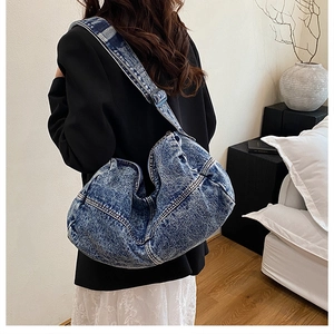 Lifestyle shot of large capacity denim crossbody tote bag paired with smart casual outfit
