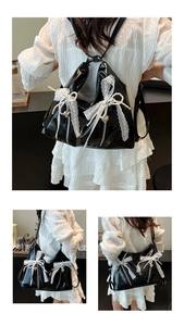 Detail of black glossy ballet-style tote bag with lace bow and pearl charms for women