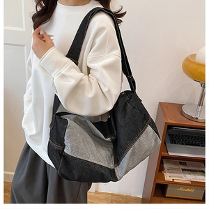 Detail view of large denim patchwork tote bag with adjustable shoulder strap