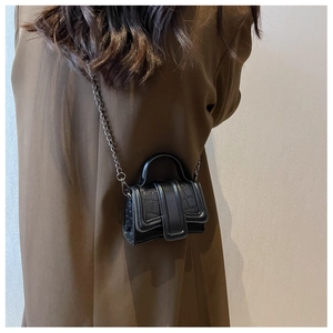 Gros plan du mini sac carré noir à motif crocodile avec chaîne sur un mannequin