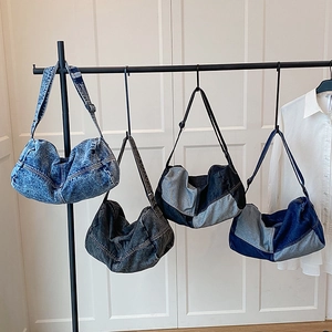 Retro denim tote bags in four vintage washes hanging on a rack for daily fashion