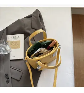 Interior view of yellow bucket bag showing spacious storage with zipper compartment