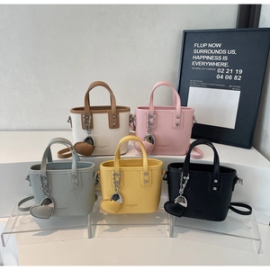 Five assorted colors of leather bucket bags with heart charms and metal chain details