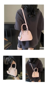 Pink patent shell bag with heart pendant shown in various stylish carrying options