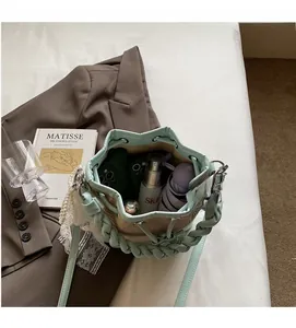 Interior view of mint green woven straw bucket bag showing spacious storage capacity