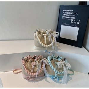 Detailed trio of straw bucket bags with lace bows and pearl accents in summer colors