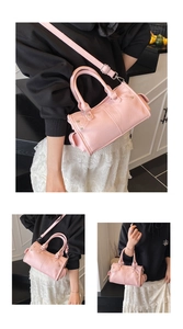 Detailed view of pink pebble grain pillow bag with dual handles and adjustable strap