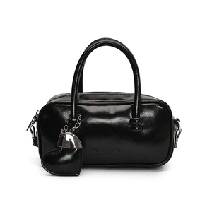 Glossy black bowling bag with top handles and heart charm pendant on white background