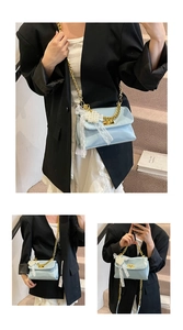 Light blue crossbody bag with gold chain, white lace bow, and pearl charm details