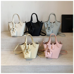 Litchi pattern leather bucket bags in five colors with mini bag charms and straps