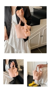 Detail of pink lychee pattern leather bucket bag with matching mini purse charm
