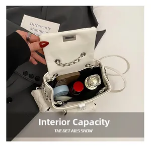 Internal capacity of white quilted leather backpack showing phone and cosmetics