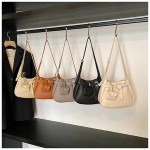 Detailed row of textured bucket bags in various colors with matching mini pouches
