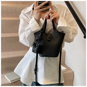 Detail of black lychee grain leather bucket bag with mini pouch and adjustable strap
