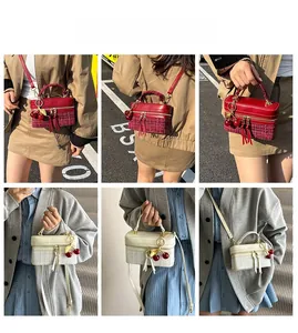 Detailed views of mini box bags in red and beige tweed with cherry charms and tassels