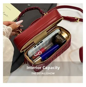 Macro view showing the spacious interior of this burgundy tweed and leather crossbody bag
