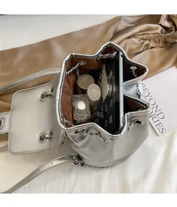 Interior view of silver drawstring bucket bag showing large capacity for tablet and cosmetics